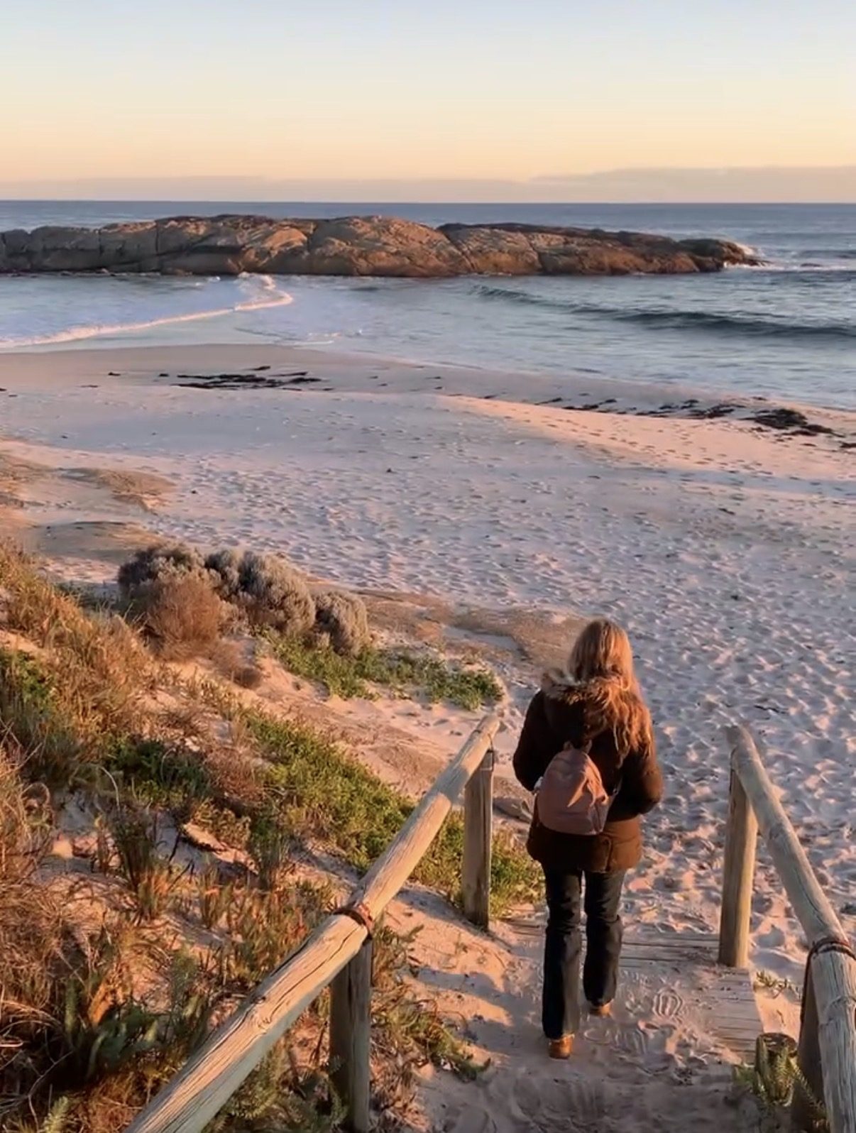 Chiara walking down to the beach at sunrise